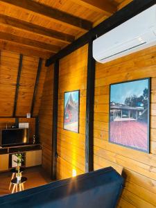 a room with wooden walls and a large window at Morada Sunset in Imaruí