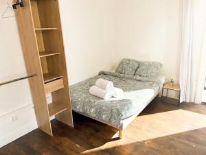 a small bedroom with a bed and a book shelf at Le Repos Poitevin Studio Atypique in Vivonne