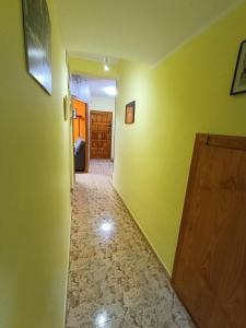 a hallway with green walls and a wooden door at Casa Rural Javier in Valmuel +32 photos