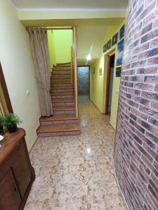 a hallway with stairs and a brick wall at Casa Rural Javier in Valmuel