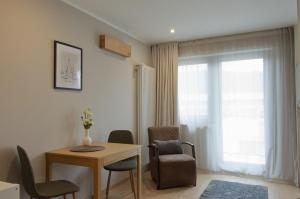 a living room with a table and chairs and a window at Wohnen bei FrauSchmitt in Bad König +41 photos