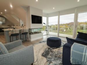 a living room with a couch and a kitchen at Portnablagh Cottage in Dunfanaghy