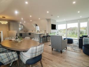 a kitchen and living room with a table and chairs at Portnablagh Cottage in Dunfanaghy