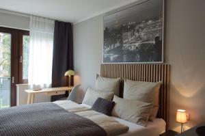 a bedroom with a bed with white sheets and pillows at Wohnen bei FrauSchmitt in Bad König
