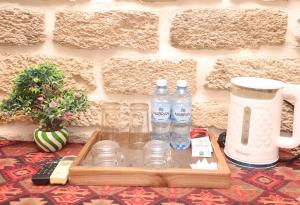 a tray with two bottles of water and glasses on a table at Green Garden Hotel in Baku
