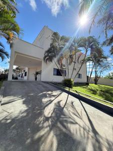 a shadow of a palm tree in front of a house at Pumma Hotel Ourilândia in Ourilândia do Norte