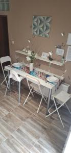 a table with two chairs and a table with plates on it at Anita in Budapest