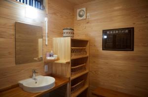 a bathroom with a sink and a mirror at 一棟宿 倉持 in Kusatsu +23 photos