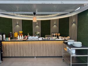 a restaurant with a counter with plates on it at WiFi Costa Adeje in Adeje