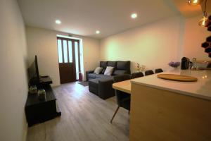 a living room with a couch and a table at Casa Ti Madalena in Arganil
