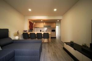 a living room with a couch and a kitchen at Casa Ti Madalena in Arganil