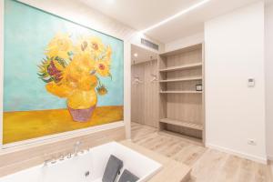 a bathroom with a painting of flowers on the wall at Max Motel - Art Gallery Room in Druento +21 photos