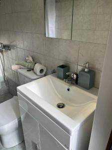 a bathroom with a white sink and a toilet at Sunrise View in Kardámyla +6 photos