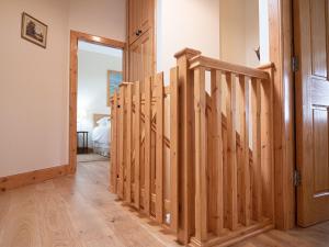 a hallway with a wooden staircase in a house at Steading Cottage - Ukc5957 in Port Appin