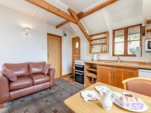 a living room with a couch and a table at Hayloft - E3759 in Berrynarbor