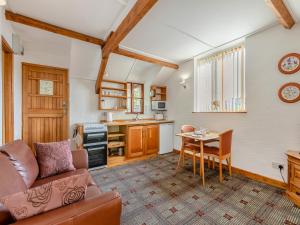 a living room with a couch and a table at Hayloft - E3759 in Berrynarbor