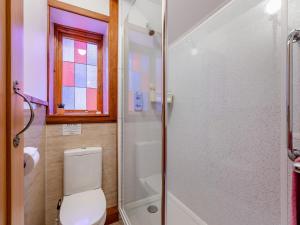a bathroom with a toilet and a glass shower at Hayloft - E3759 in Berrynarbor