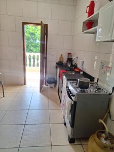 a kitchen with a stove and a counter top at Silsol in Itacaré