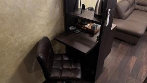 a living room with a chair and a television at Vendi Grand Square Residence in Sibiu +13 photos