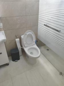 a bathroom with a toilet and a sink at Casa Nury in Santo Domingo