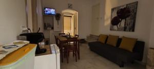 a living room with a couch and a table at Adalù apartments in Conversano