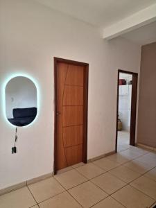 a room with a wooden door and a window at Silsol in Itacaré