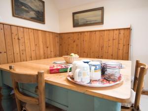a table with a plate of food on it at Coachman's Bothy - Ukc5958 in Port Appin