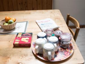 a wooden table with jars and a basket of apples at Coachman's Bothy - Ukc5958 in Port Appin +6 photos