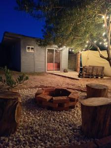 a fire pit in the middle of a yard at night at El refugio in La Paloma
