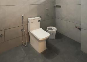 a bathroom with a toilet and a bidet at Skylora Heights Inn in Kozhikode