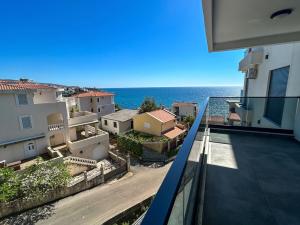 a view of the ocean from the balcony of a building at Sea & Stone Edge Suites in Dobra Voda