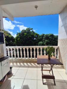 a view from the balcony of a house with a table at Silsol in Itacaré