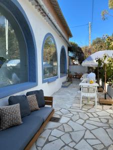 a patio with a couch and a table and chairs at Hotel Princesse D'Azur in Sainte-Maxime