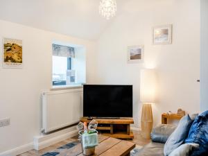 a living room with a large flat screen tv at Gracie's in Alnwick