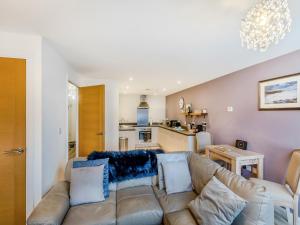 a living room with a couch and a kitchen at Gracie's in Alnwick