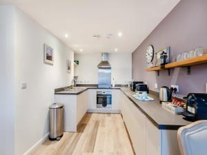 a kitchen with white cabinets and a counter top at Gracie's in Alnwick +10 photos