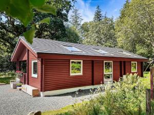 a red tiny house in a garden at Ard Darach Lodge in Dunoon
