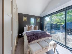a bedroom with a bed and a large window at Lower Peastocking in Meriden +14 photos