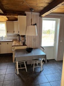 a kitchen with a table with a bowl on it at Torpidyll nära sjö in Vetlanda
