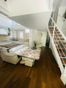a bedroom with a bed and a staircase at DEA DREAMS - Lofty Marghera in Milan