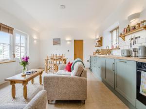 a kitchen with two chairs and a table in a room at Wren - Uk50152 in Stalisfield