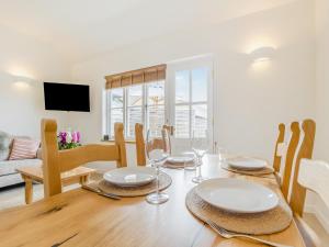 a dining room and living room with a table and chairs at Wren - Uk50152 in Stalisfield +23 photos