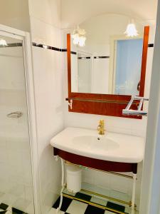a bathroom with a sink and a mirror at Maison d'hôtes Villa Meinga in Saint-Coulomb +69 photos