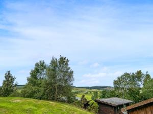 a house on a hill with a green field at The Curious Stag in Rothbury