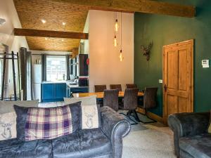 a living room with a couch and a table at The Curious Stag in Rothbury +8 photos
