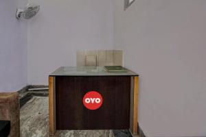 a wooden table with a noo sign on it at Hotel O Rest & Zone Hotel in Greater Noida