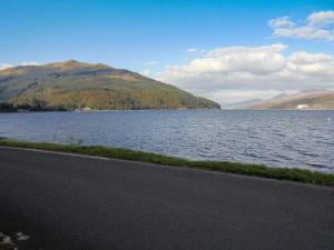 a view of a lake with mountains in the background at Raglan Cottage in Ardentinny +9 photos