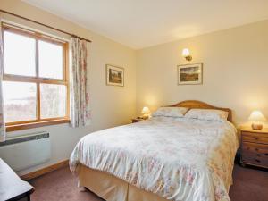 a bedroom with a bed and a window at Moy in Taynish