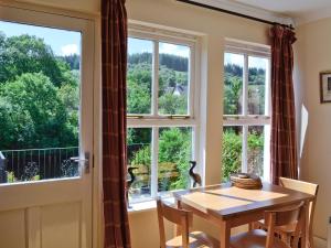 a dining room with a table and a window at Dunardry View in Lochgilphead