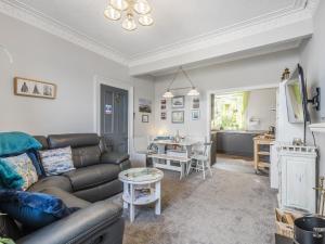 a living room with a couch and a table at Pier Haven - Cottage in Blairmore